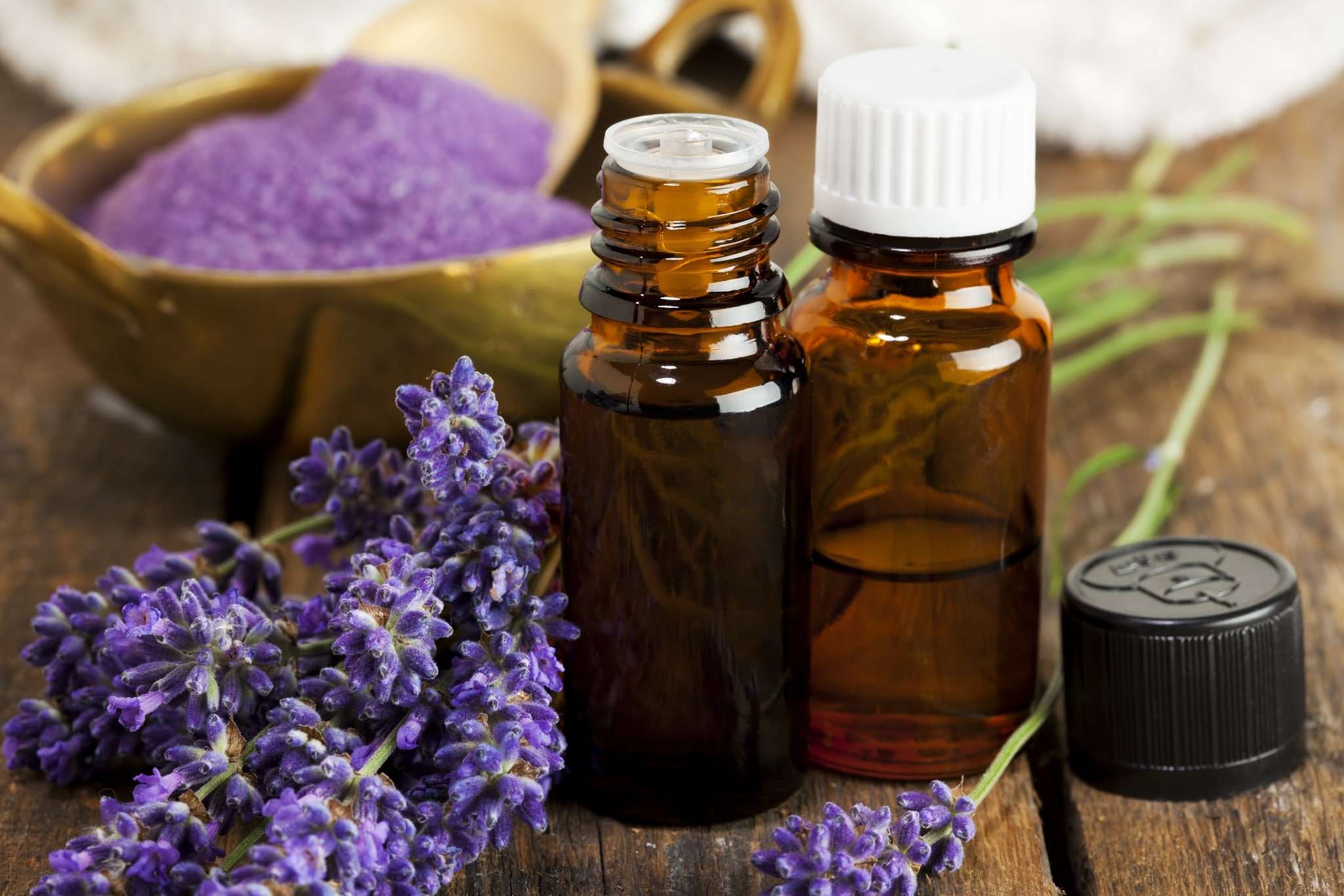 Lavender essential oils in brown glass jars.