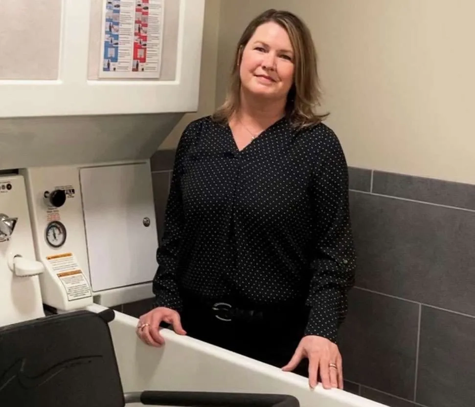 Julie standing by apollo bath tub