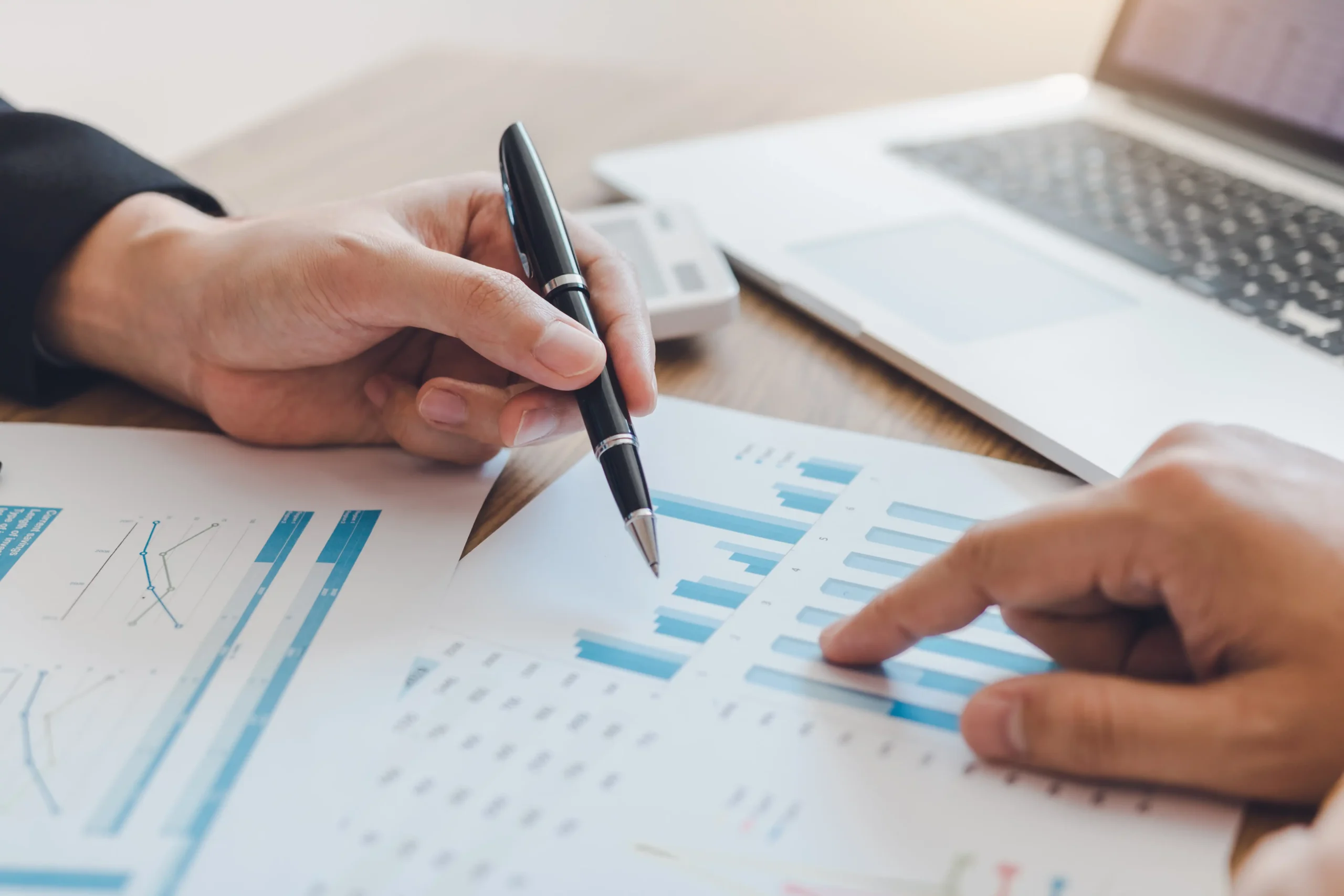 Finance & Leasing 2 Hands going over financial documents and charts; Apollo Bath financing and leasing options make ADA-compliant walk-in tubs affordable for all budgets