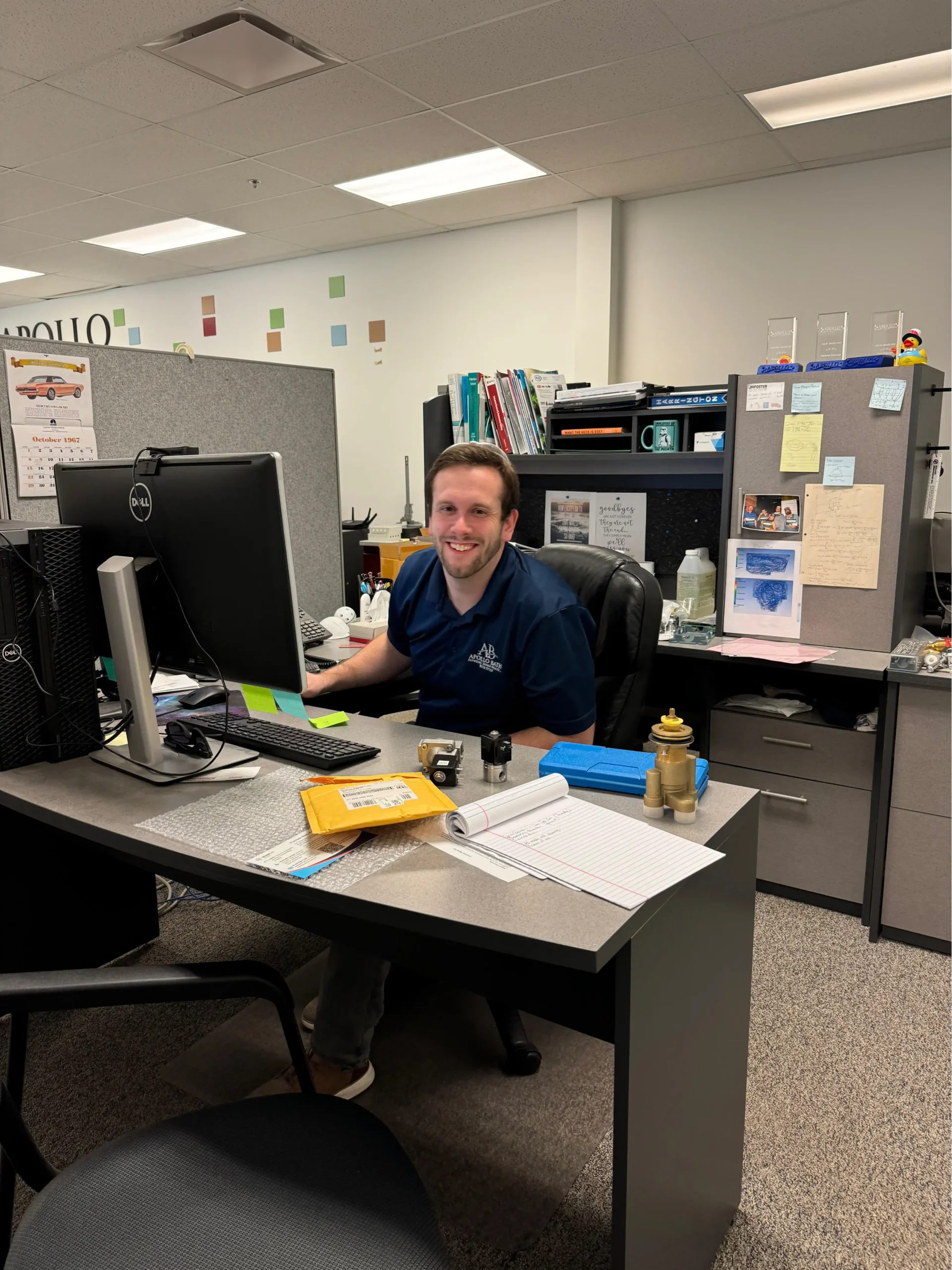 Apollo Bath employee working at their desk, ensuring top-quality hydrotherapy tubs and elderly bathtub solutions
