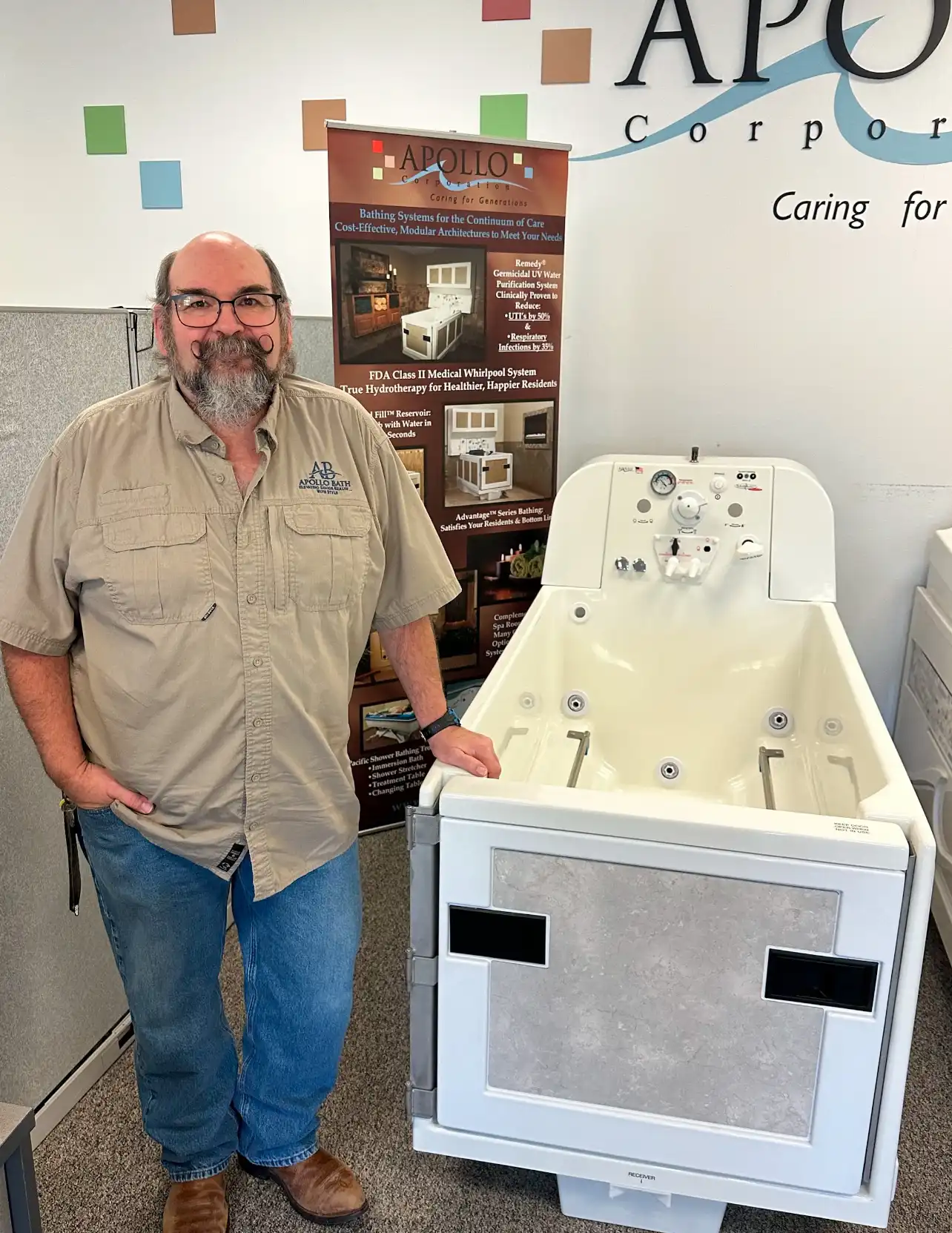 Apollo Bath team member showcasing Apollo walk-in tub with hydrotherapy features for elderly bathing solutions