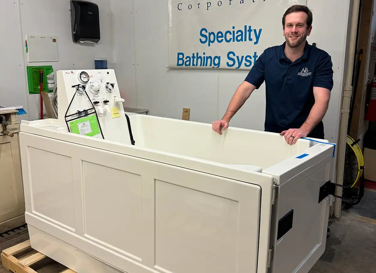 Apollo Bath team member showcasing Apollo walk-in tub designed for seniors and disabled users